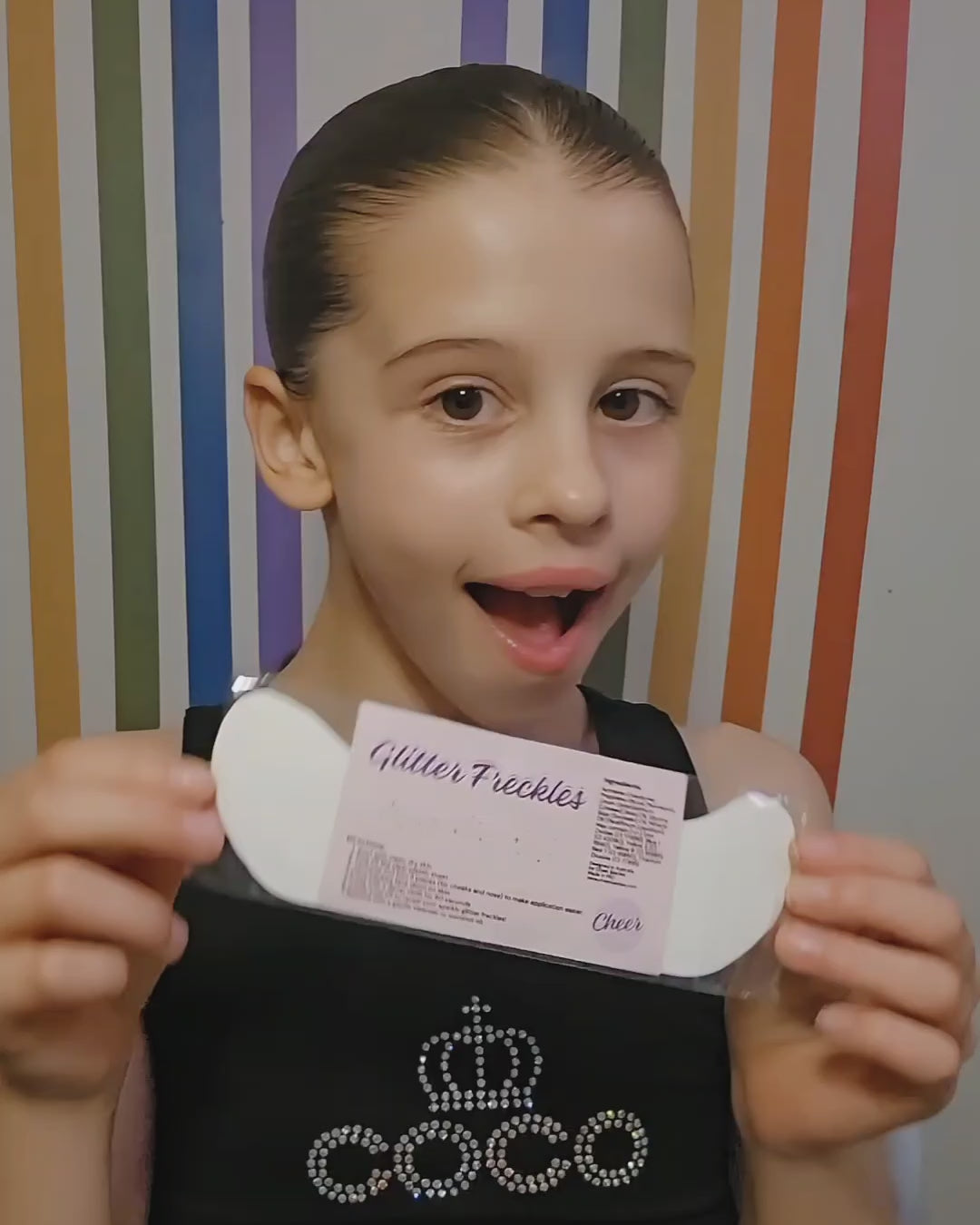 Load video: young girl applying glitter freckles